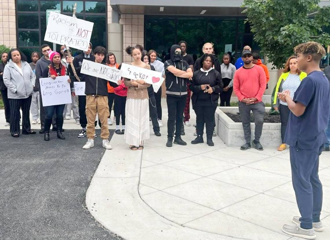 Olathe student David Brox leads protesters in chants Monday evening in front of school district headquarters. Students are demanding that district officials take stronger steps to combat racism and discipline students for harassment and discrimination.