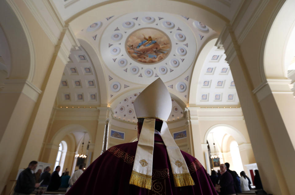 Baltimore Archbishop William Lori proceeds into the Basilica of the National Shrine of the Assumption of the Blessed Virgin Mary for an Ash Wednesday Mass in Baltimore, Wednesday, March 5, 2014. Ash Wednesday marks the beginning of the Lenten season, a time when Christians commit to acts of penitence and prayer in preparation for Easter Sunday. (AP Photo/Patrick Semansky)