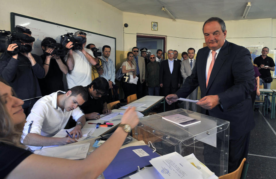 Former conservative Prime Minister Costas Karamanlis casts his ballot in Thessaloniki, northern Greece Sunday May 6, 2012. Greeks cast ballots on Sunday in their most critical _ and uncertain _ election in decades, with voters set to punish the two main parties that are being held responsible for the country's dire economic straits. (AP Photo/Giorgos Nissiotis)