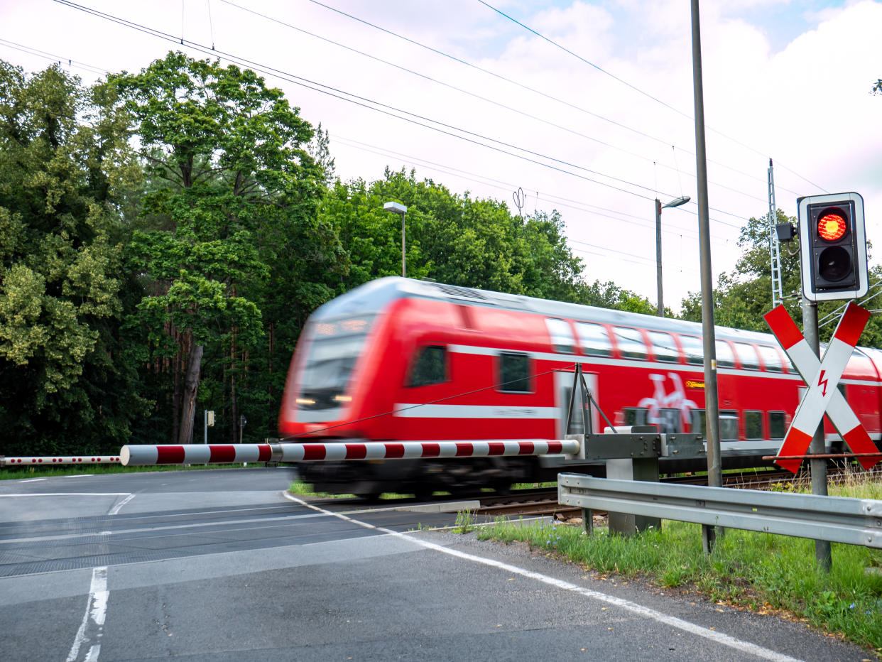 train in motion at the level crossing