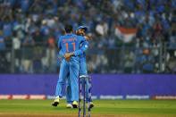 India's captain Rohit Sharma hugs teammate Mohammed Shami after India won the ICC Men's Cricket World Cup first semifinal match against New Zealand in Mumbai, India, Wednesday, Nov. 15, 2023. (AP Photo/Rajanish Kakade)