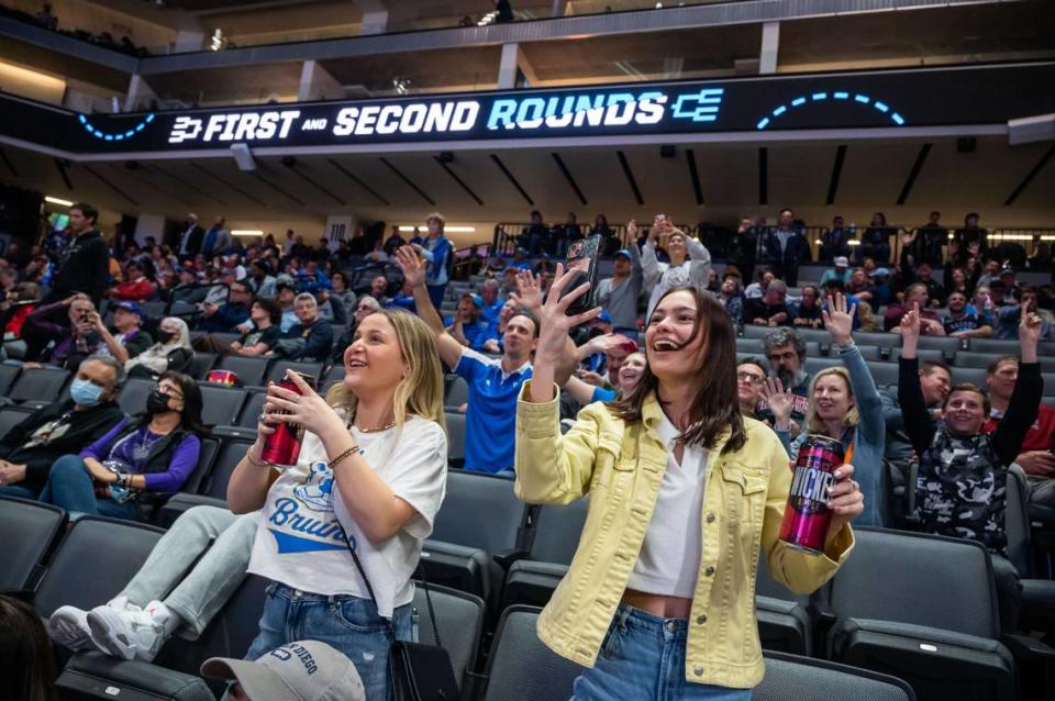 UCLA students Elena Bateman, left, a Sacramento native, and Elsie Paulsen cheer their UCLA Bruins as they play the UNC Asheville Bulldogs during the second half of the NCAA Tournament game at Golden 1 Center. UCLA beat UNC Asheville, 86-53.