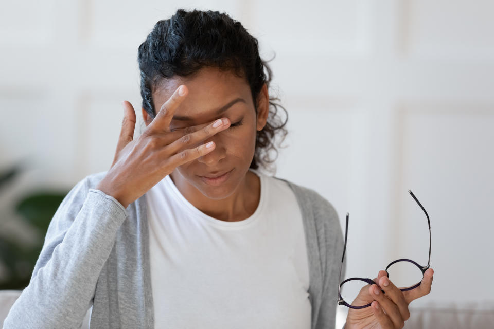 Woman itching eyes. (Getty Images)