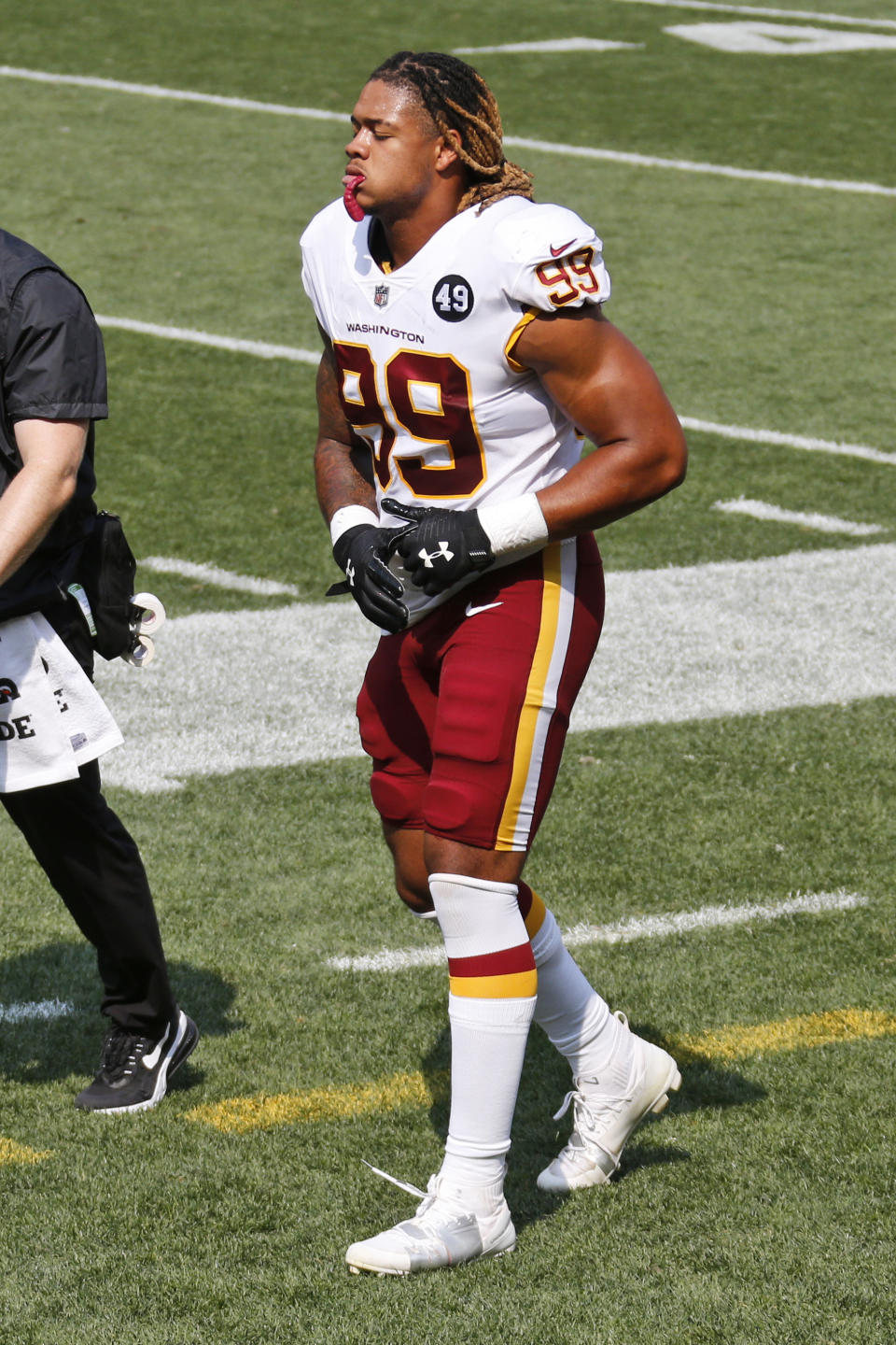 Washington Football Team defensive end Chase Young limps back to the locker room during the first half of an NFL football game against the Cleveland Browns, Sunday, Sept. 27, 2020, in Cleveland. (AP Photo/Ron Schwane)