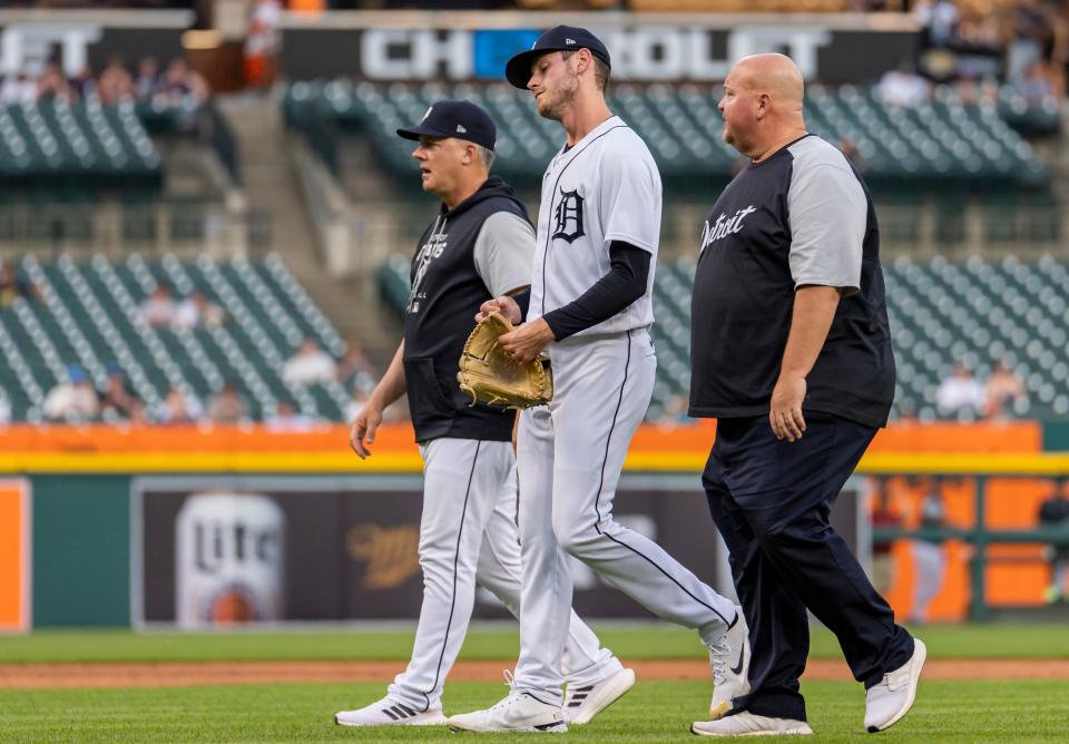 Tigers pitcher Joey Wentz leaves the game with manager AJ Hinch, left, and head athletic trainer Doug Teter during the fifth inning of Game 2 of a doubleheader against the Twins on Tuesday, May 31, 2022, at Comerica Park.