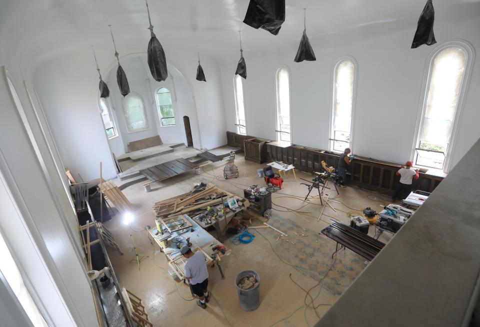 Workers restore the interior of the former Saint John the Baptist church at 3 Grand Street in the City of Poughkeepsie on July 24, 2023. The church closed in 2007, and is currently being renovated into an event space.  