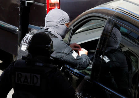 French police and members of special Police units RAID conduct an investigation after two Frenchmen were arrested in Marseille, France, April 18, 2017 for planning to carry out an "imminent and violent attack" ahead of the first round of the presidential election on Sunday, France's interior minister said. REUTERS/Philippe Laurenson 