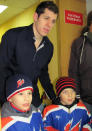 Evgeni Malkin gets photo taken with two young fans. (#NickInEurope)