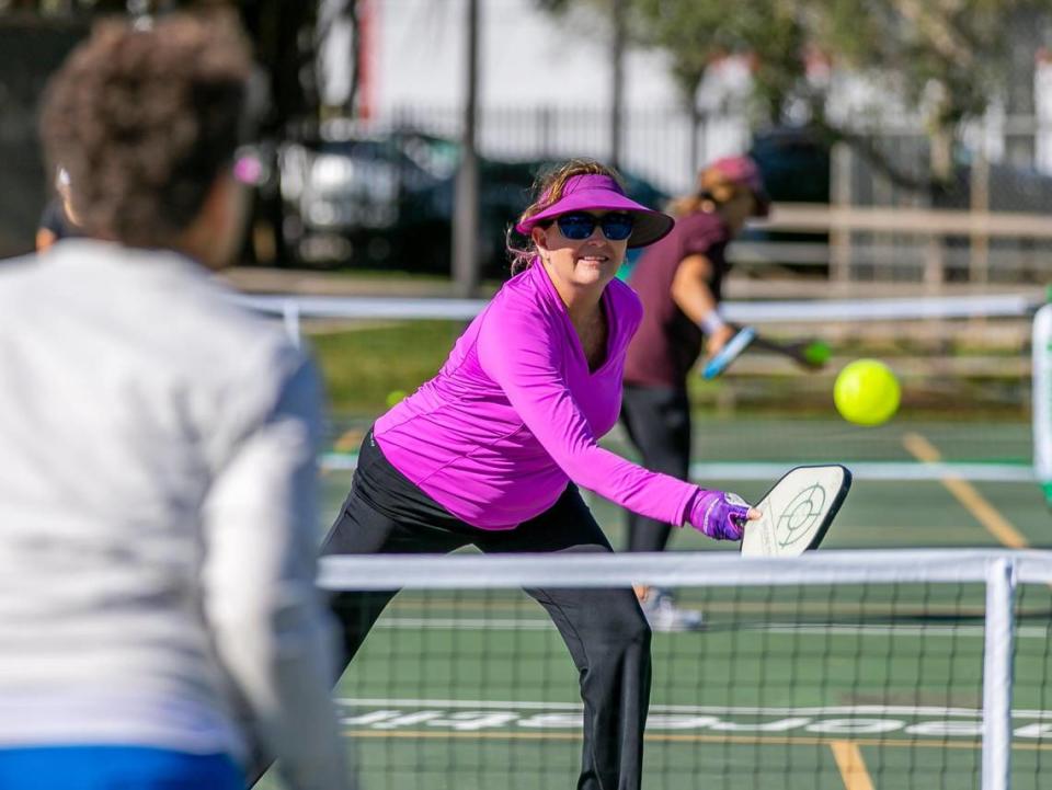 Lori Davison, 54, plays a game of pickleball at Suniland Park in Pinecrest, Florida on Friday, January 14, 2022.