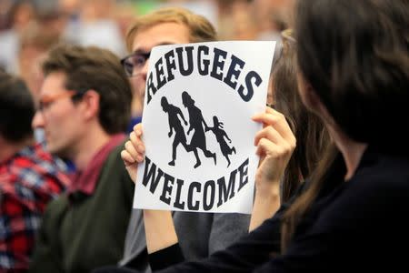 Students display placards during the speech of Norbert Hofer, Joint Acting President of Austria and Third President of the National Council, during a panel discussion on "Can Europe’s politicians solve its migration crisis?" at Geneva's graduate institute, in Geneva, Switzerland, October 20, 2016. REUTERS/Pierre Albouy