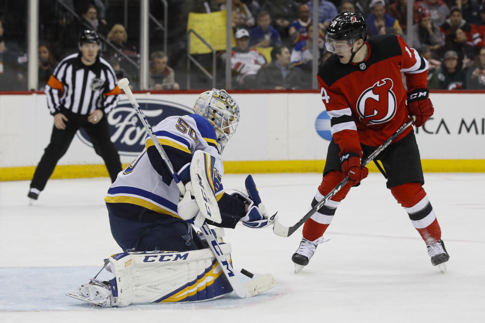 St. Louis Blues goaltender Jordan Binnington (50) makes a save during the second period of an NHL hockey game against the New Jersey Devils, Friday, March 6, 2020, in Newark. (AP Photo/John Minchillo)