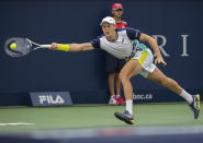 Emil Ruusuvuori, of Finland, lunges for the ball during his first-round match against Stan Wawrinka, of Switzerland, at the National Bank Open tennis tournament in Montreal, Monday, Aug. 8, 2022. (Graham Hughes/The Canadian Press via AP)