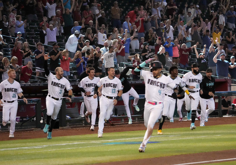 Arizona Diamondbacks players and fans celebrate as second baseman Ketel Marte (4) scores the game-winning run against the Colorado Rockies on June 1.