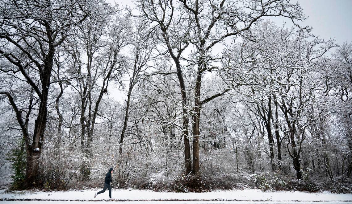 Roads were slick and schools were closed Thursday, but that didn’t mean it was all bad in the aftermath of a snowstorm that hit the South Sound. Here, a jogger cruises through a wintry scene in DuPont on Thursday, Dec. 1, 2022. The forecast calls for rain Friday with partly sunny skies over the weekend.