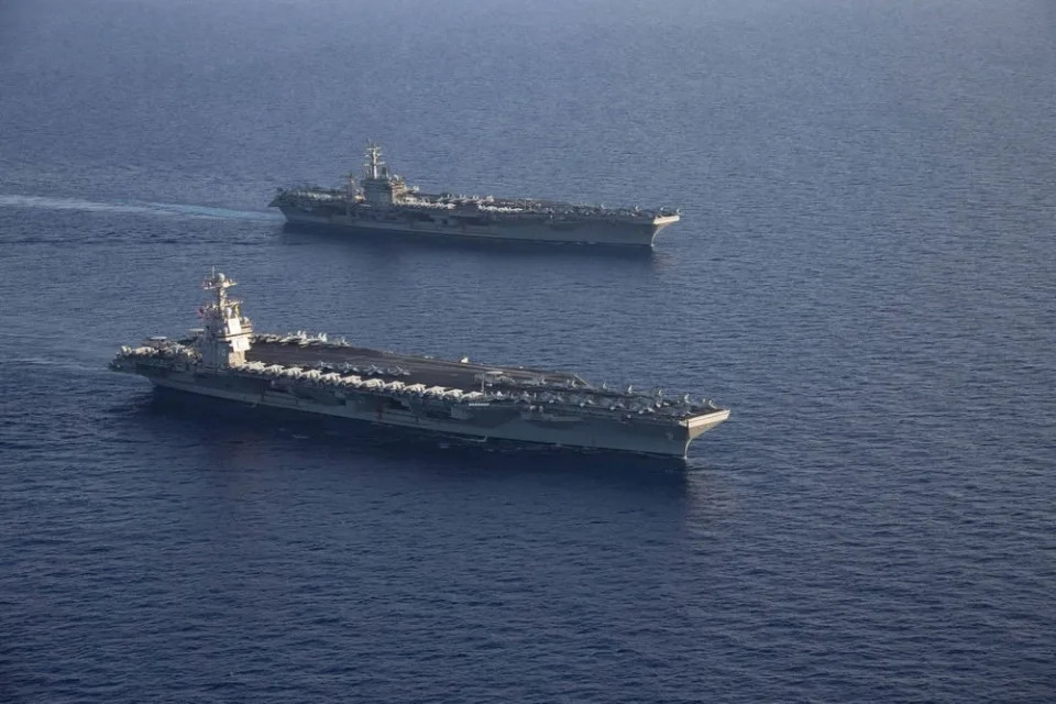 The first-in-class USS Gerald R. Ford and the Nimitz-class USS Dwight D. Eisenhower sail in formation in the Mediterranean Sea.
