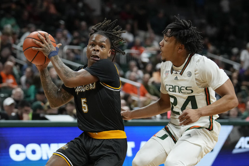 La Salle guard Khalil Brantley (5) is defended by Miami guard Nijel Pack (24) during the first half of an NCAA college basketball game, Saturday, Dec. 16, 2023, in Coral Gables, Fla. (AP Photo/Rebecca Blackwell)