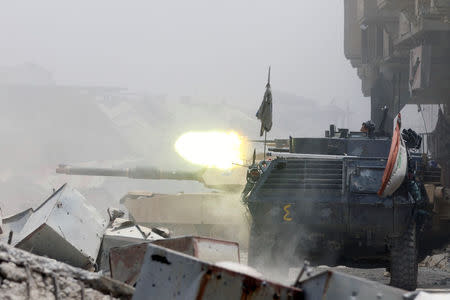 An armoured personnel carrier of Iraqi security forces fire against Islamic State militants at the frontline in the Old City of Mosul, Iraq July 7, 2017. REUTERS/Ahmed Saad