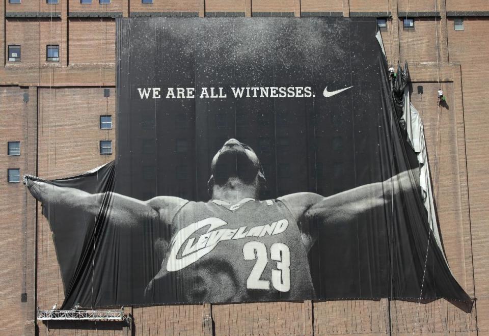 A 10-story banner of LeBron James is taken down by workers in downtown Cleveland on July 11, 2010. (AP/Amy Sancetta)
