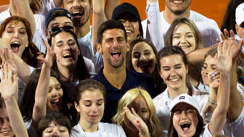 Novak Djokovic (pictured middle) posting for a photo with the Adria Tour tournament volunteers in 2020.