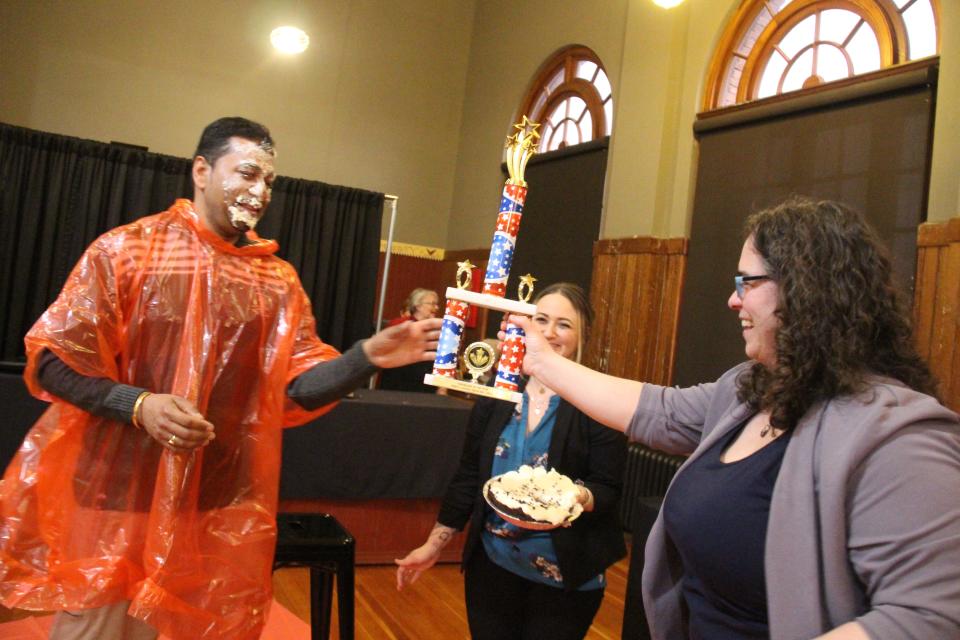 Perry Chamber Executive Director Lynsi Pasutti hands Deepak Nayyar the Big Boom Bracket Battle Trophy during the grand finale on Tuesday, April 4, 2023, at La Poste.