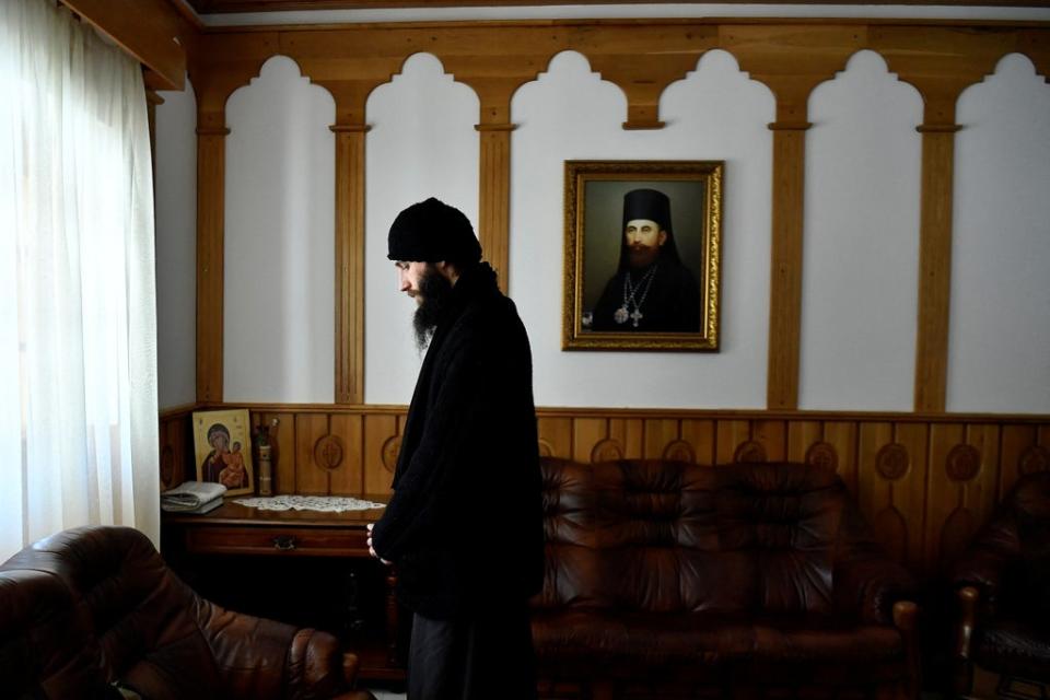 Father Gherasim Soca closes his eyes in reflection (Reuters)