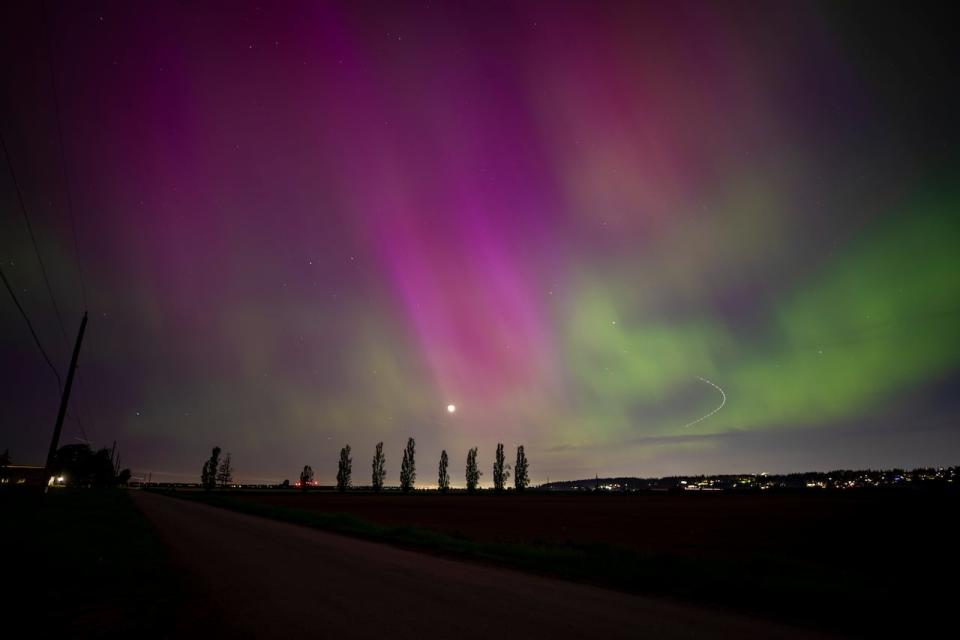 A long-exposure photo shows the aurora borealis in Surrey, B.C., on Friday, May 10, 2024.