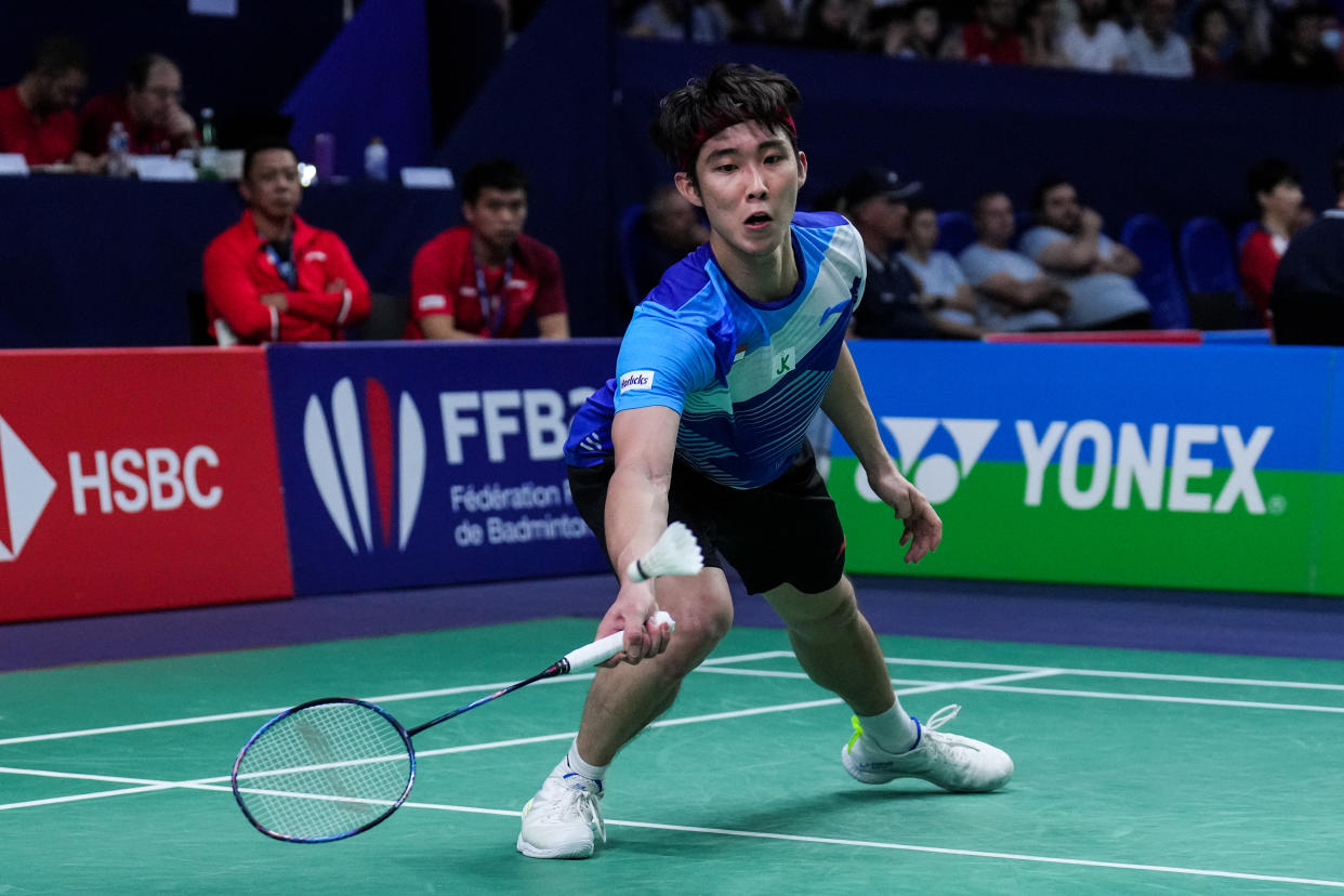 Singapore shuttler Loh Kean Yew stoops to retrieve a shot at the French Open. 