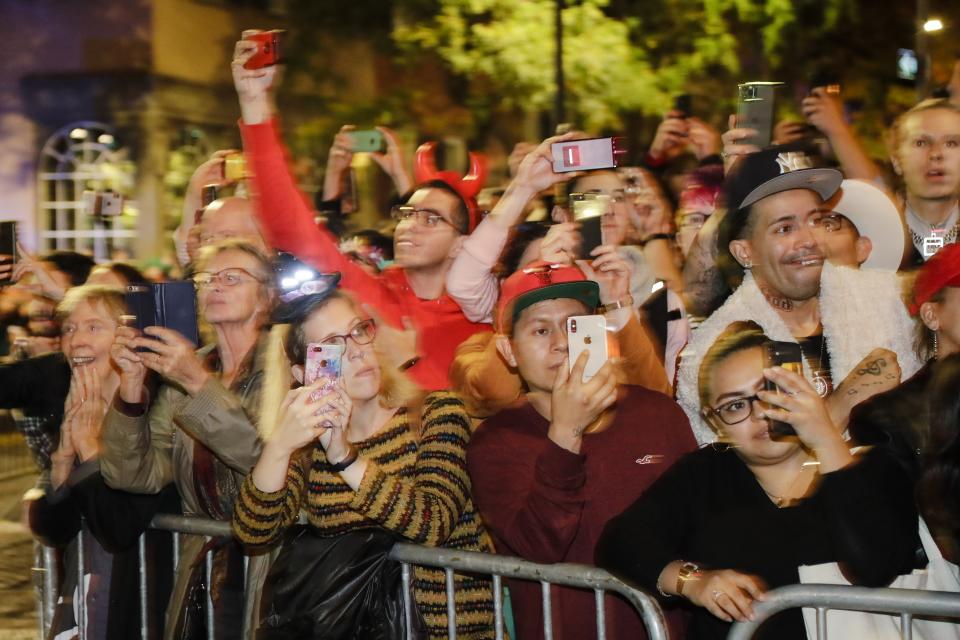 People react to revelers marching during the Greenwich Village Halloween Parade, Thursday, Oct. 31, 2019, in New York. (AP Photo/Frank Franklin II)