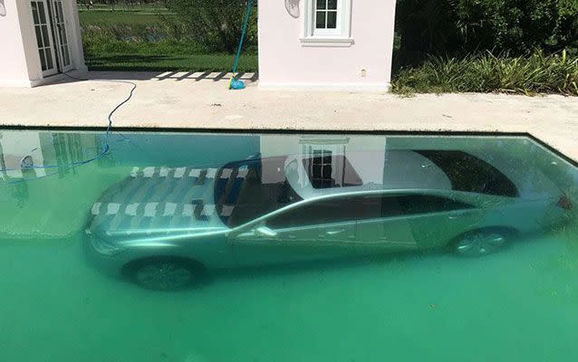 The Mercedes Benz is submerged in the banker's pool. Picture: Guy Gentile