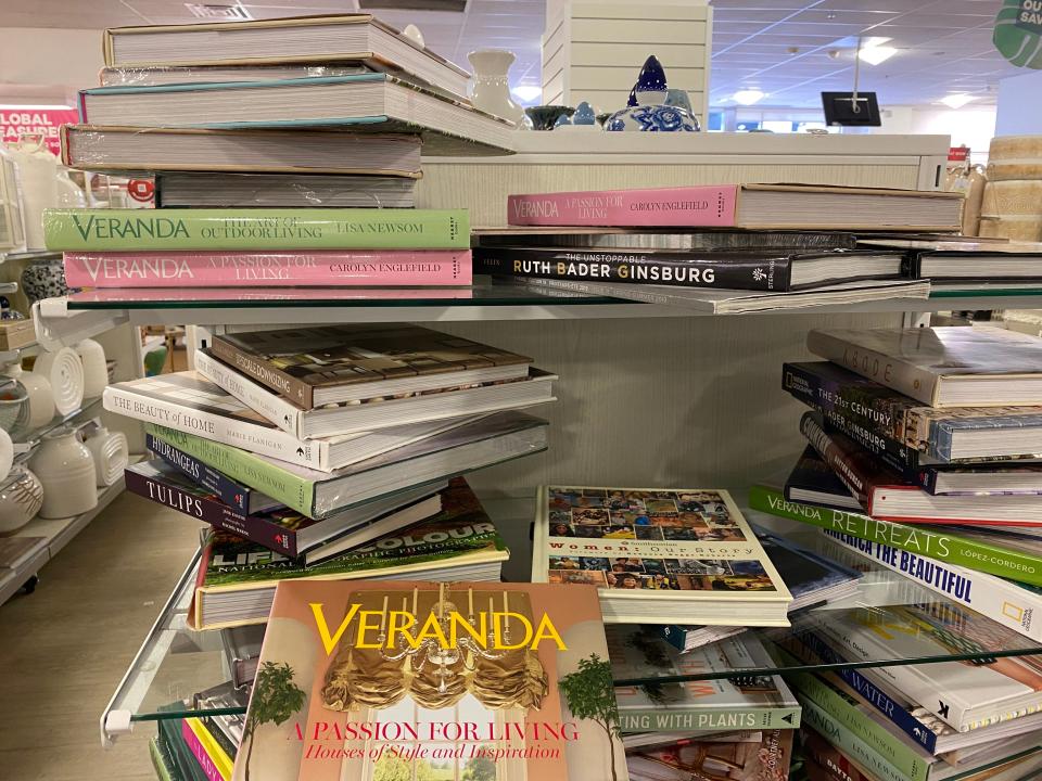 piles of coffee-table books on glass shelves in homegoods