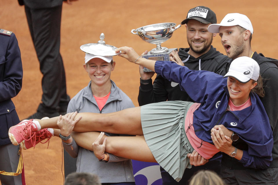 Poland's Iga Swiatek celebrates with the winner's trophy after defeating Czech Republic's Karolina Pliskova at the final match of the Italian Open tennis tournament, in Rome, Sunday, May 16, 2021. Swiatek won 6-0, 6-0. (AP Photo/Gregorio Borgia)