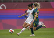 United States' Christen Press, left, is challenged by Australia's Ellie Carpenter during a women's soccer match at the 2020 Summer Olympics, Tuesday, July 27, 2021, in Kashima, Japan. (AP Photo/Fernando Vergara)