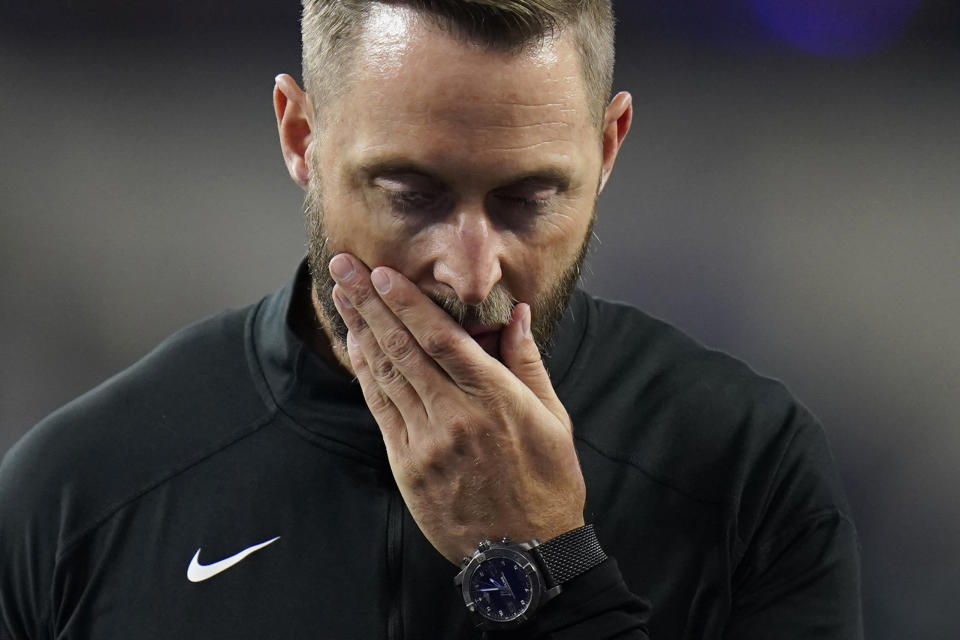 Arizona Cardinals head coach Kliff Kingsbury walks off the field after the Los Angeles Rams defeated the Cardinals in an NFL wild-card playoff football game in Inglewood, Calif., Monday, Jan. 17, 2022. (AP Photo/Jae C. Hong)