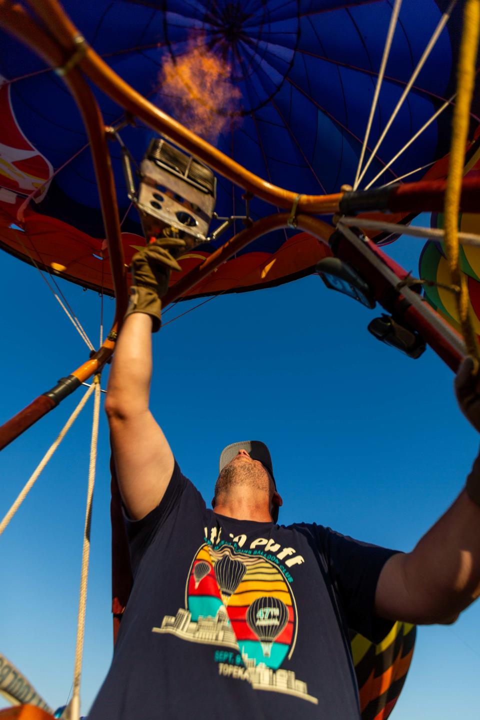 Above southwest Topeka, Tony Goodnow fires the burner on the Libertas hot air balloon. Goodnow, now 47, has grown up around hot air balloons all his life, and he pointed out the west Topeka field from which his late father allowed him to pilot his first solo flight at age 16.