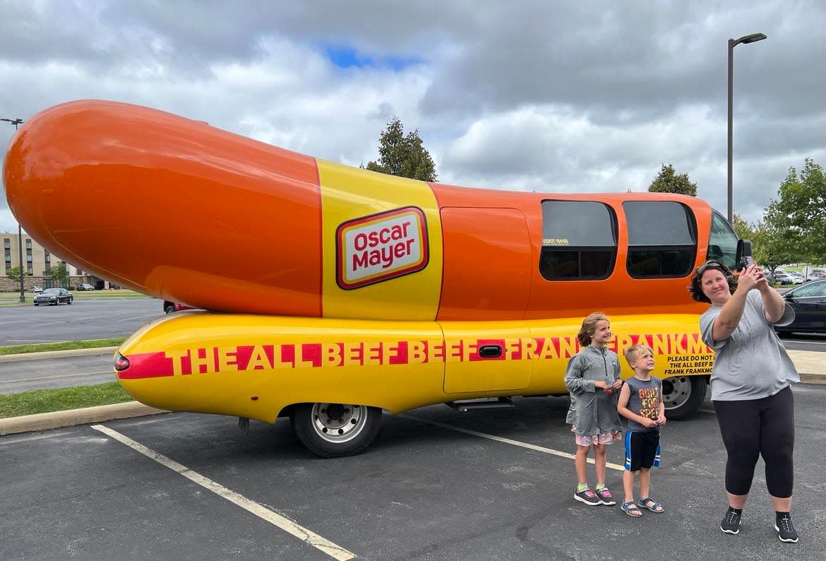 A family takes a selfie with the Oscar Mayer Frankmobile. The unique vehicle will be in downtown Canton from 5 to 9 p.m. today at Centennial Plaza during First Friday activities.