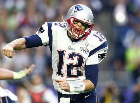 Feb 1, 2015; Glendale, AZ, USA; New England Patriots quarterback Tom Brady (12) celebrates after throwing a touchdown pass against the Seattle Seahawks in the second quarter in Super Bowl XLIX at University of Phoenix Stadium. Mark J. Rebilas-USA TODAY Sports