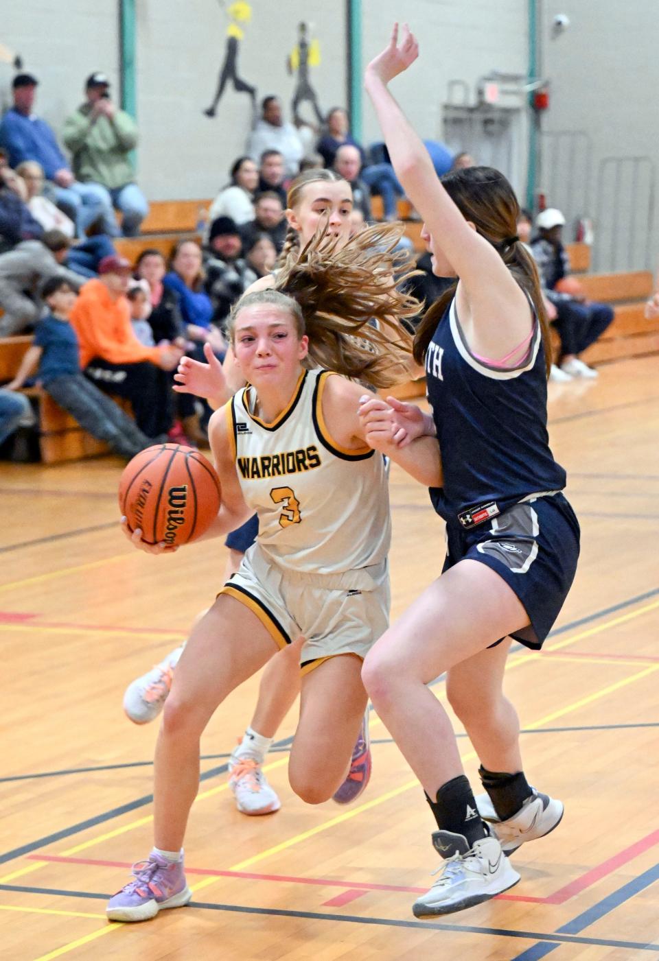 Jordyn Streitmatter of Nauset drives the lane against Lila Connolly of Plymouth North during a game Friday in Orleans.