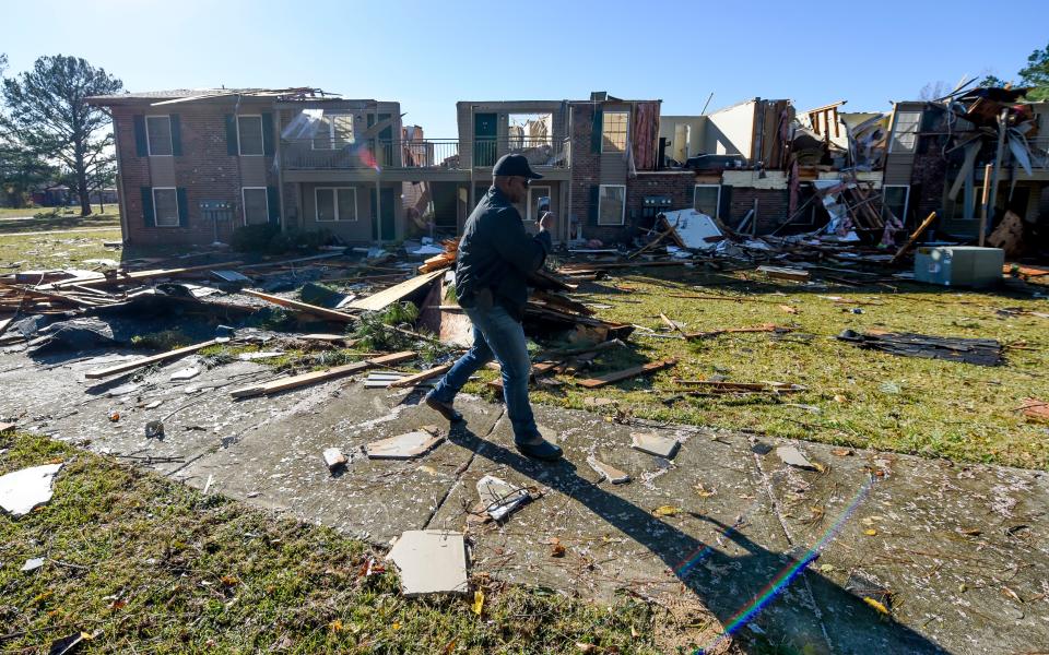 Nov 30, 2022; Eutaw, Alabama, USA;  Eutaw Police Chief Tommy Johnson surveys the damage to one of the buildings in the Sagewood Apartments complex in Eutaw, Ala., after a small tornado hit the town located in Greene County Tuesday, Nov. 29, 2022. No injuries were reported from the storm.