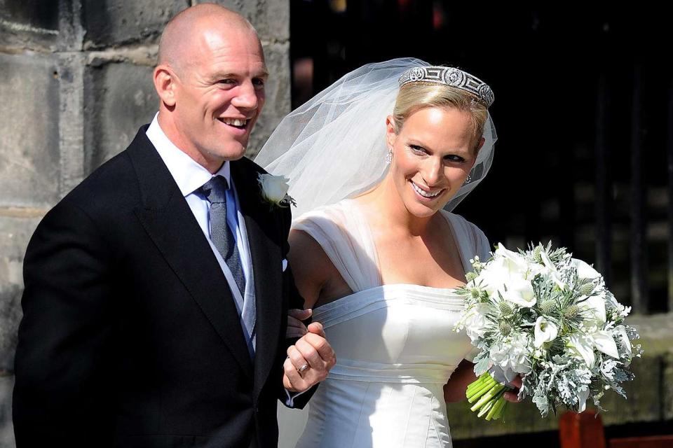 <p>Martin Rickett/PA Images via Getty Images</p> Mike Tindall and Zara Phillips emerge from Canongate Kirk church on their July 30, 2011 wedding day.