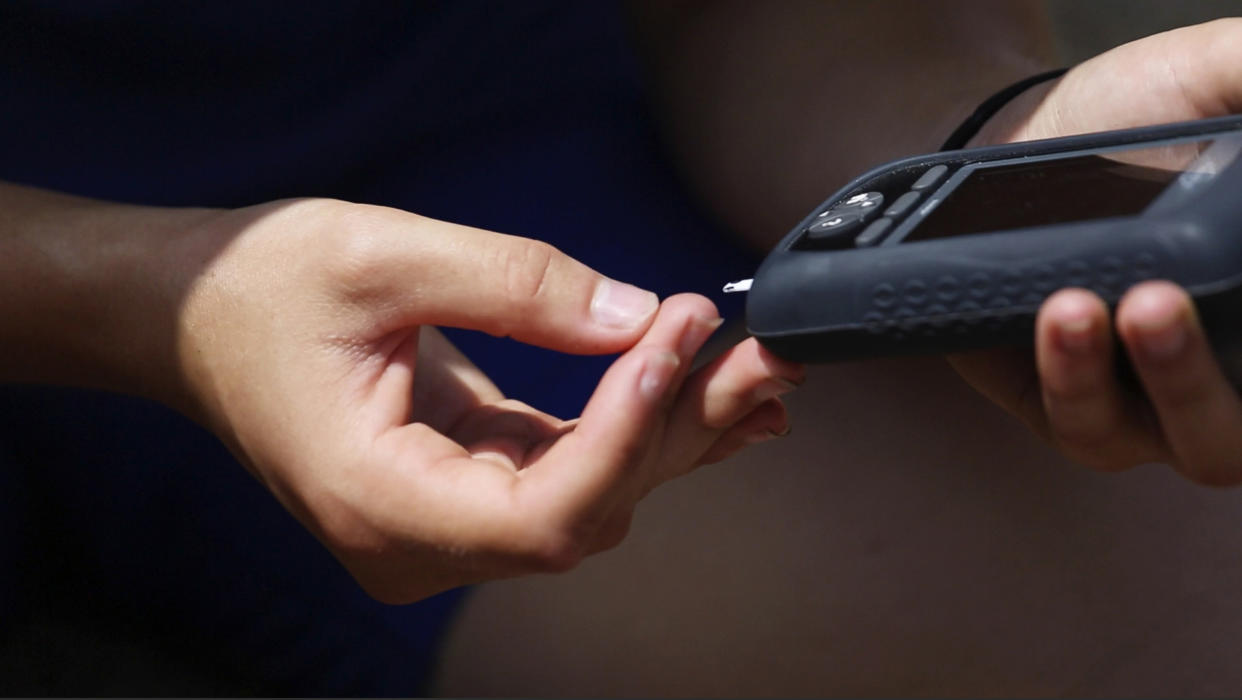 A&nbsp;woman checks her blood sugar level. (Photo: Portland Press Herald via Getty Images)