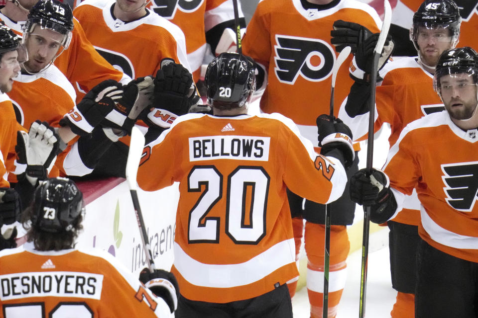 Philadelphia Flyers' Kieffer Bellows (20) returns to the bench after scoring during the first period of an NHL hockey game against the Pittsburgh Penguins in Pittsburgh, Saturday, March 11, 2023. (AP Photo/Gene J. Puskar)