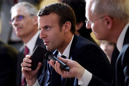 President of the French space agency CNES (Centre national d'etudes spatiales - National Centre for Space Studies) Jean-Yves Le Gall (R) looks on as French President Emmanuel Macron speaks on the phone to French astronaut Thomas Pesquet at the CNES headquarters in Paris, France, June 2, 2017, during an event to watch a live broadcast of Pesquet's and Russian cosmonaut Oleg Novitskiy's landing in Kazakhstan, ending their marathon 196-day mission to the International Space Station. REUTERS/Stephane De Sakutin/Pool