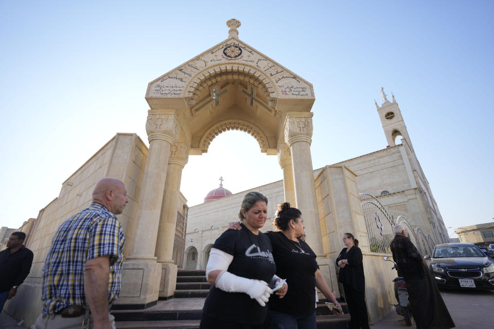 Iraqi Christians react after attending a mass at the Grand Immaculate Church, of Hamdaniya, Nineveh province, Iraq, Friday, Sept. 29, 2023. Iraq's prime minister on Thursday visited injured patients and the families of victims in northern Iraq days after a deadly wedding fire killed around 100 people. (AP Photo/Hadi Mizban)