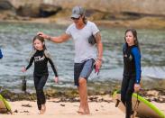 <p>Country-legend Keith gave his youngest a pat on the head as they waked up to meet Nicole. Both girls looked exhausted after their long day in the surf.</p>