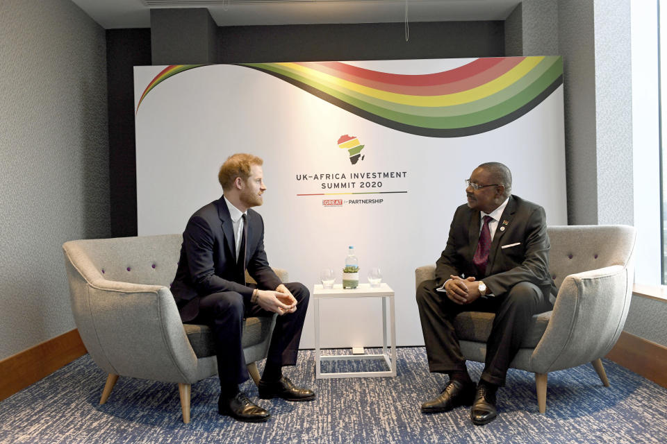 Britain's Prince Harry meets with President of Malawi, Arthur Peter Mutharika, right, at the UK Africa Investment Summit in London, Monday Jan. 20, 2020. Britain's Prime Minister Boris Johnson is hosting 54 African heads of state or government in London, as the U.K. prepares for post-Brexit dealings with the world. (Stefan Rousseau/Pool via AP)