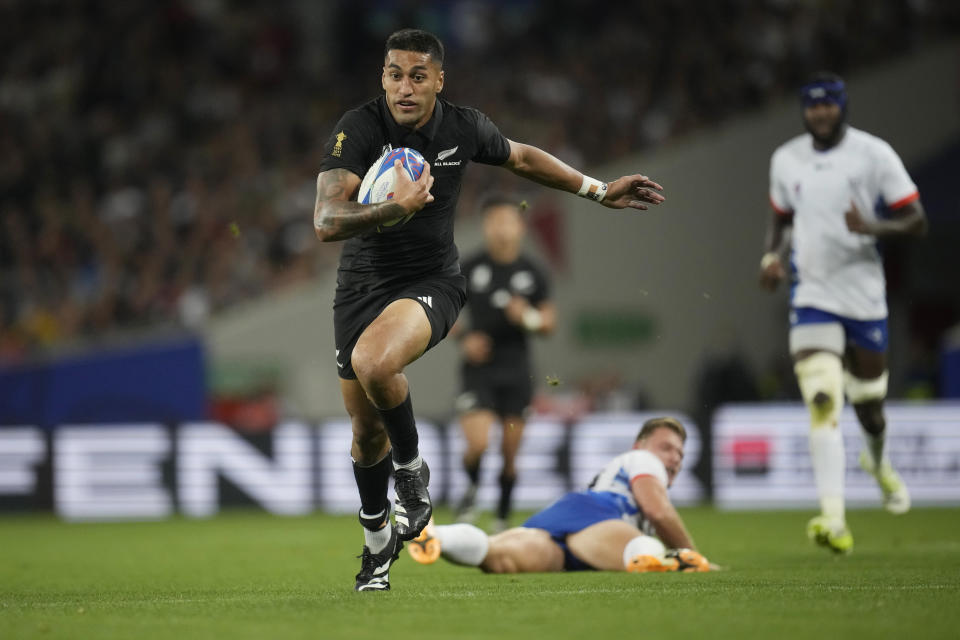 New Zealand's Rieko Ioane runs to score a try with Damian McKenzie during the Rugby World Cup Pool A match between New Zealand and Namibia at the Stadium de Toulouse in Toulouse, France, Friday, Sept. 15, 2023. (AP Photo/Christophe Ena)