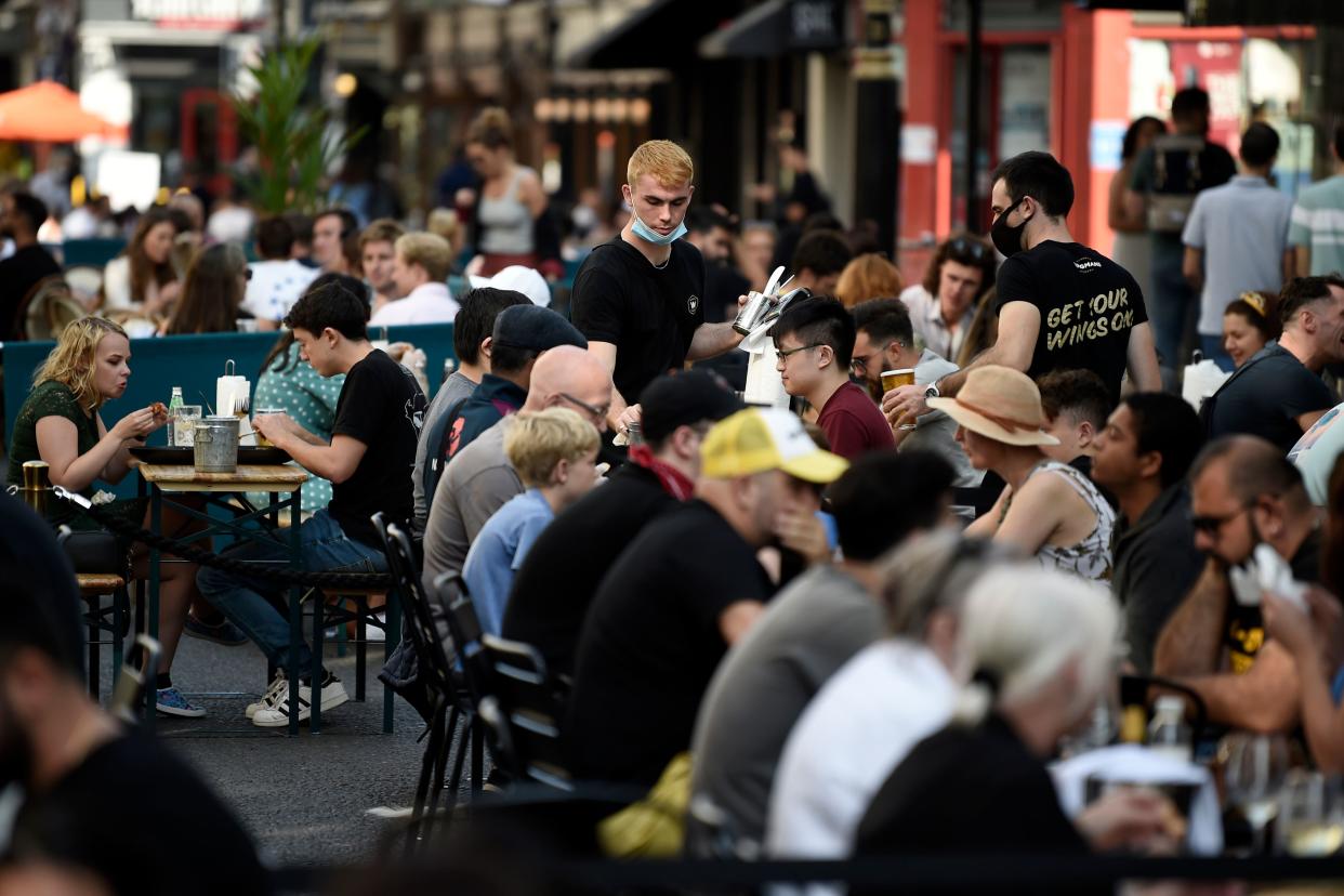 TOPSHOT - Customers eat sunday lunches at tables outside restaurants in Soho, in London on September 20, 2020 as the British government consider fresh nationwide restrictions after an rise in cases of the novel coronavirus. - The government this week tightened restrictions on socialising because of a surge in coronavirus cases, and imposed local lockdowns across swathes of the country. (Photo by DANIEL LEAL-OLIVAS / AFP) (Photo by DANIEL LEAL-OLIVAS/AFP via Getty Images)