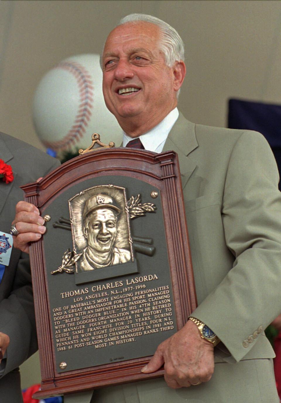 Tommy Lasorda poses with his Hall of Fame plaque after his induction Sunday, Aug. 3, 1997 in Cooperstown, N.Y. (AP Photo/ Dave Jennings)