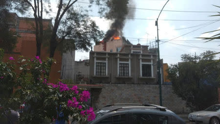 A building is seen on fire following an earthquake, in the district of colonia Roma, Mexico city, Mexico September 19, 2017 in this still image obtained via social media. MIGUEL ANGEL QUISBERTH CORDERO/ via REUTERS