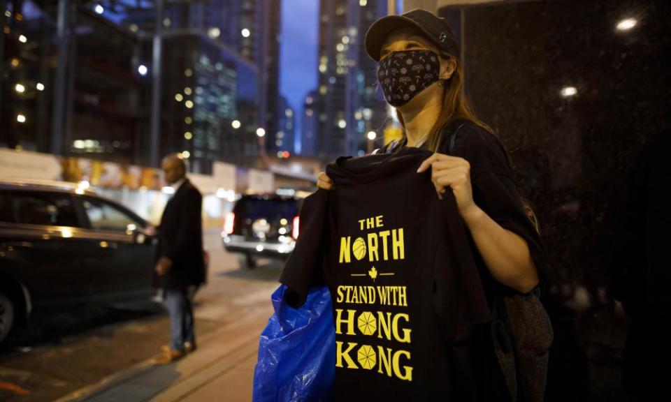 Pro-Hong Kong activists hand out t-shirts outside of the Toronto Raptors game on Tuesday